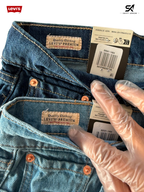 Close-up of Levi's jeans with a hand wearing a transparent glove pointing to the brand label.